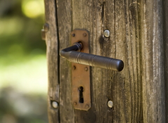 Old wooden door with rusty iron handle