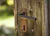 Old wooden door with rusty iron handle