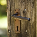 Old wooden door with rusty iron handle